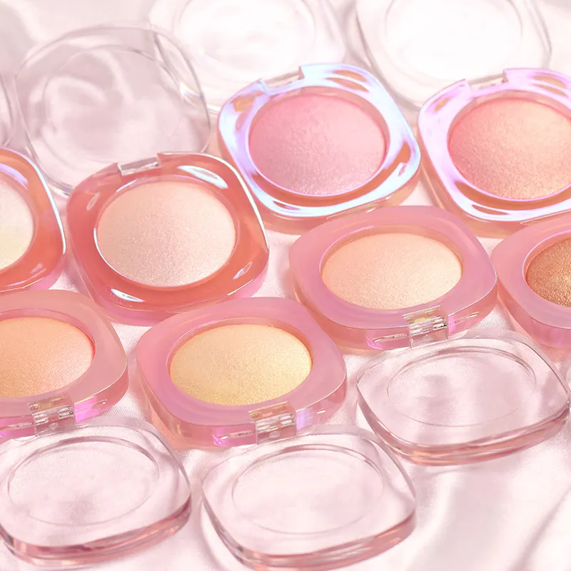 Various shades of compact blushes with transparent lids on a silky surface.