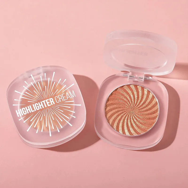 Two containers of highlighter cream, one closed and one open showing shimmering swirls.