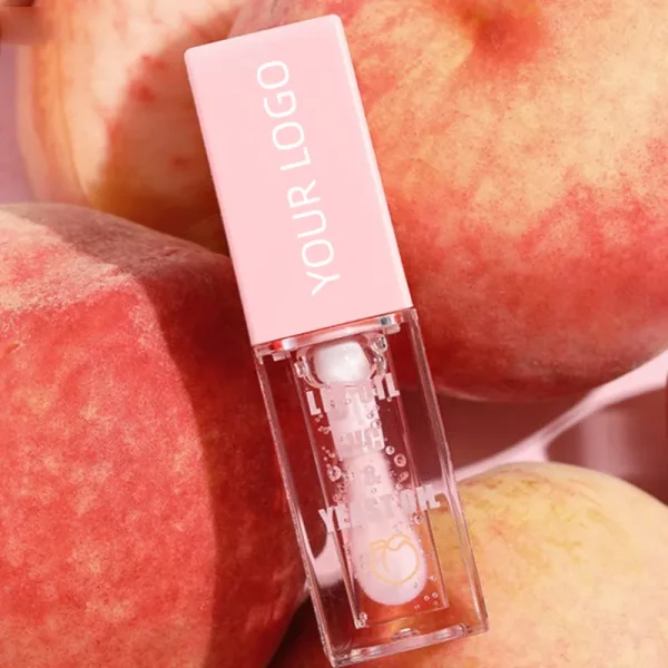 A clear lip gloss with a pink cap labeled 'Your Logo' placed in front of ripe peaches.