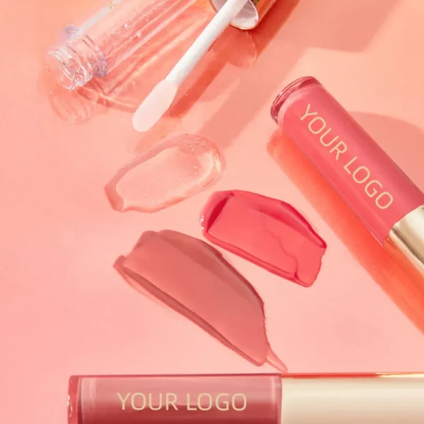 Lip gloss tubes and swatches on a pink background
