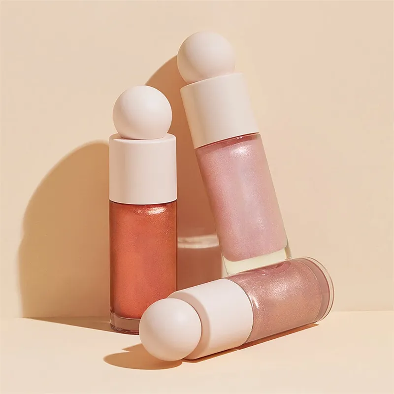 Three tubes of Liquid Highlighter with rounded caps in pink and peachy shades on a beige background.