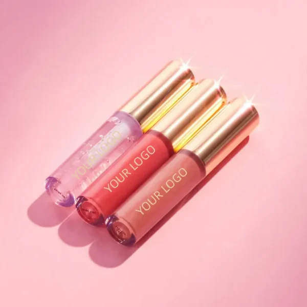 Three lip gloss tubes with gold caps on a pink background.