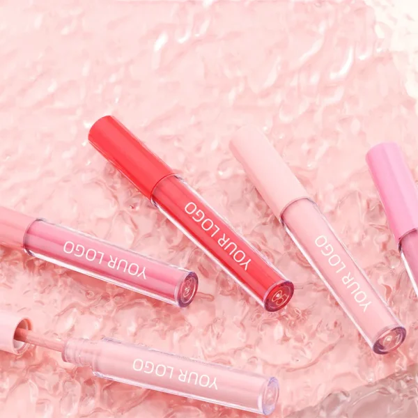 Five tubes of lip gloss with a variety of shades in red and pink on a textured pink surface, each labeled 'Your Logo'.