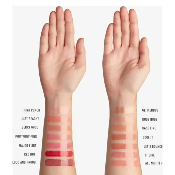 Two arms displaying swatches of various lipstick shades labeled with names such as Pink Punch, Just Peachy, and Glitterbug.