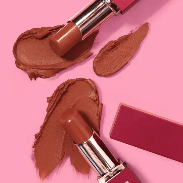 Two Tinted Lip Balm with smears of brown lipstick on a pink background.