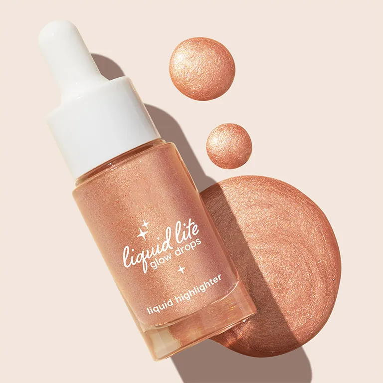 Bottle of liquid lite glow drops with drops of highlighter