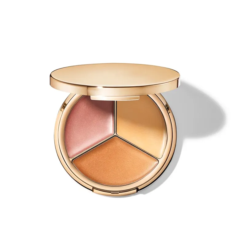 A round makeup compact with three beige and pink shades inside.