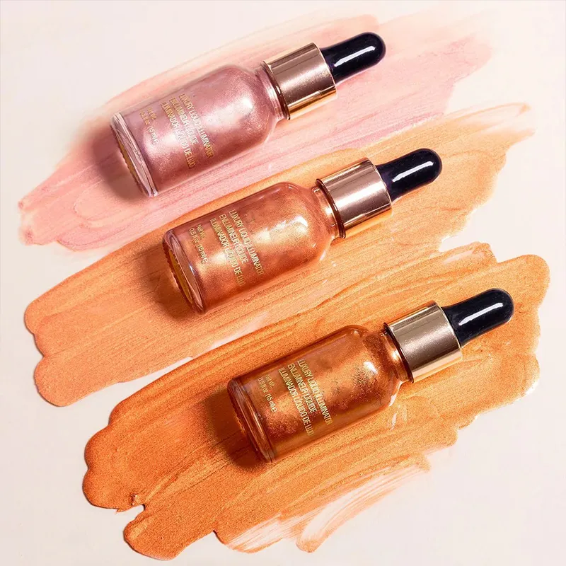 Three bottles of makeup illuminating drops on painted swatches in shades of pink and orange.