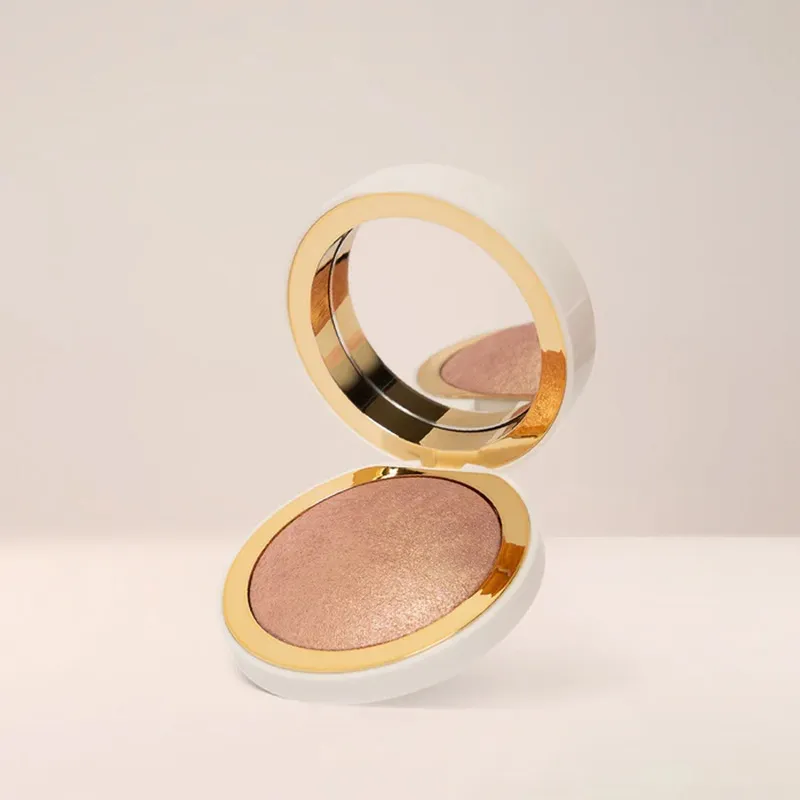 An open compact case with a mirror and makeup powder inside.