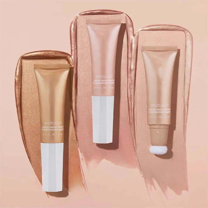 Three tubes of liquid highlighter with makeup strokes in the background.