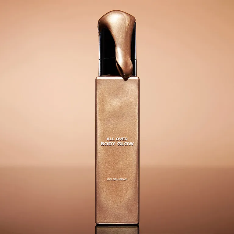 A bottle labeled 'All Over Body Glow' with liquid dripping from the top.