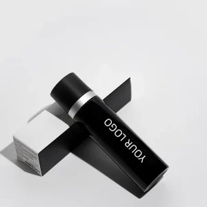 Black cylindrical cosmetic bottle with silver accent lying on a black and white box, featuring placeholder text 'YOUR LOGO'.