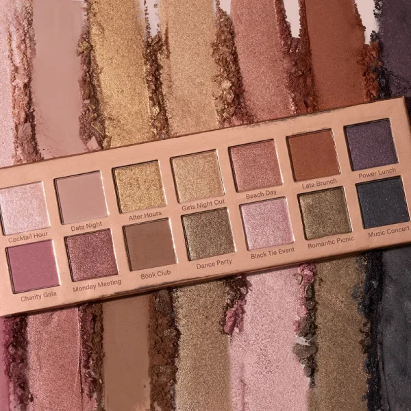 A makeup palette with various shades of eyeshadow colors labeled with creative names