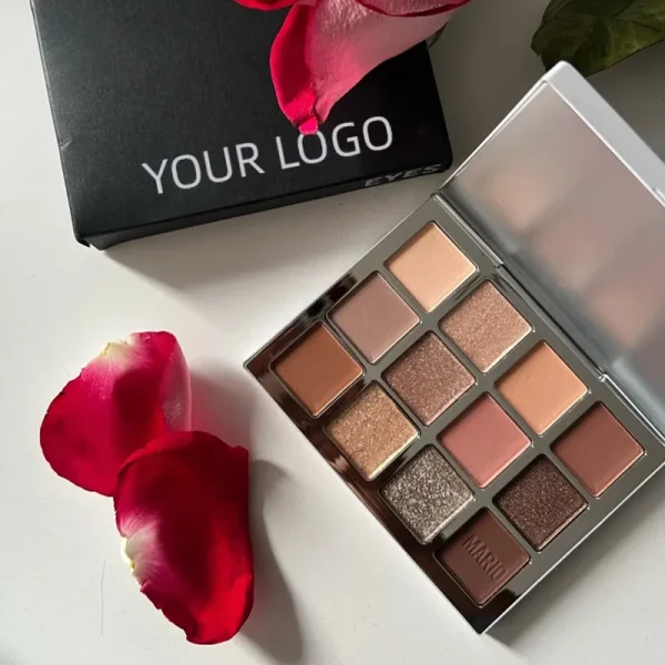 A calm scene featuring a vibrant eyeshadow palette by Makeup by Mario, with red rose petals adding a touch of elegance