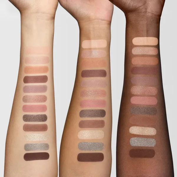 Three arms showing eyeshadow swatches in a variety of colors across different skin tones.