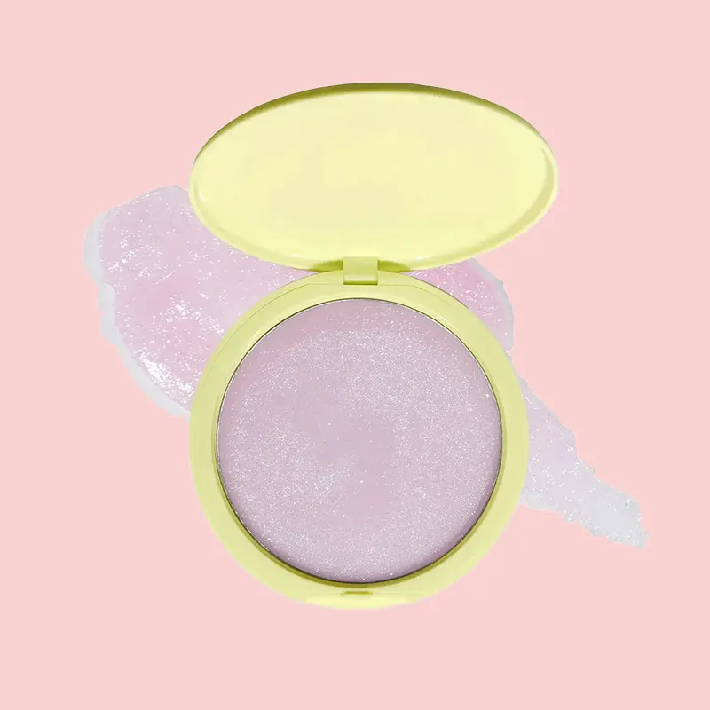 Open compact with pink highlighter on a pink background.