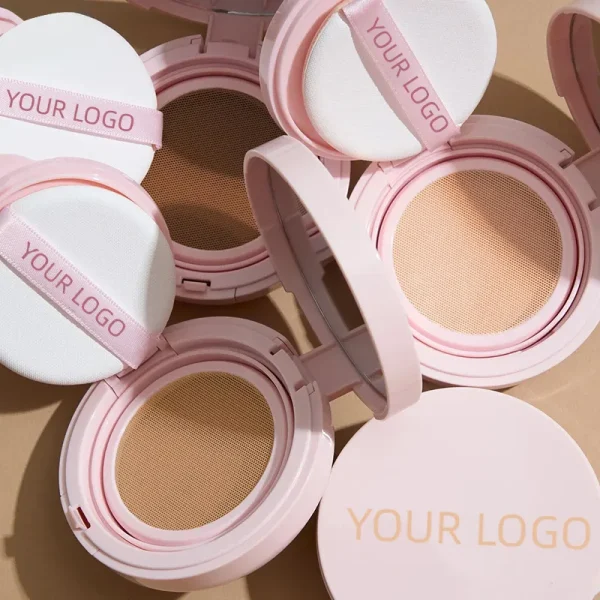 Pink makeup compacts with applicators labeled 'Your Logo' on display