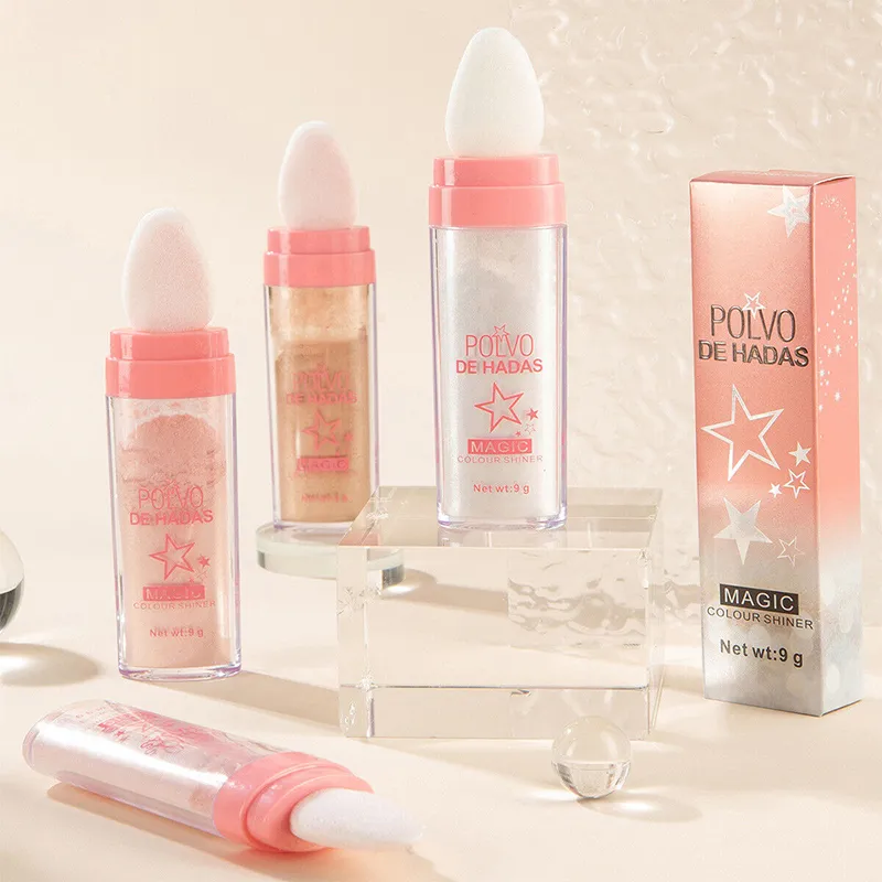 A set of Polvo De Hadas cosmetic shiners with pink caps and a packaging box.