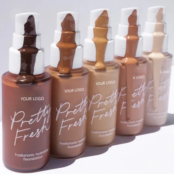 Five bottles of Pretty Fresh hyaluronic hydrating foundation in various skin tones with product overflow on top.