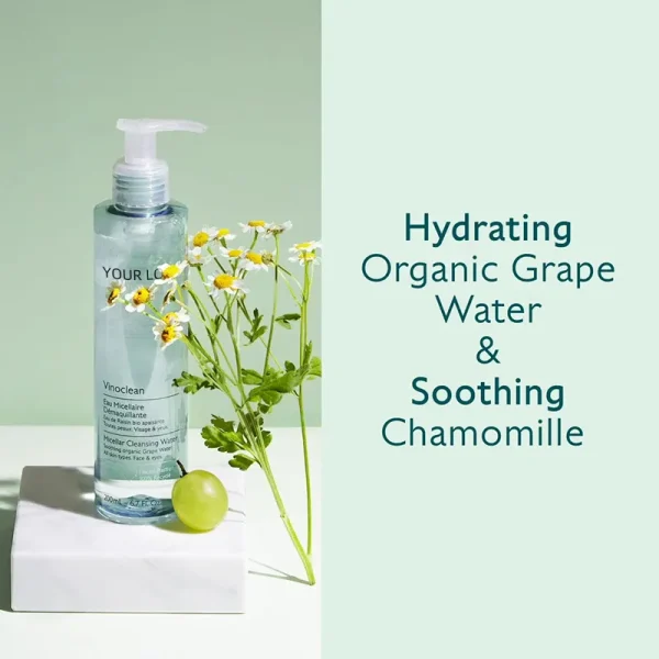 Bottle of Vinoclean Micellar Cleansing Water beside chamomile flowers and a green grape on a white surface with text reading 'Hydrating Organic Grape Water & Soothing Chamomile'.