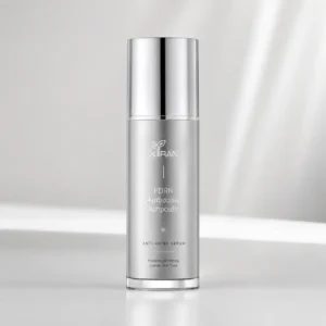 Xiran PDRN Skinbooster Ampoule in silver bottle with sleek design, labeled as a hydrating and firming anti-aging serum for uneven skin tone.