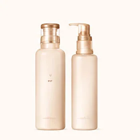 Two beige cosmetic pump bottles standing side by side, featuring minimalistic design on a light background.