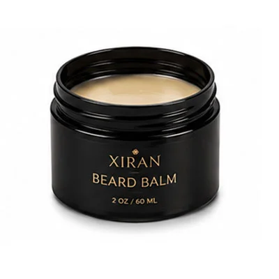 A black jar labeled 'Xiran Beard Balm' dengan 2 oz / 60 ml capacity, filled with a beige beard balm.